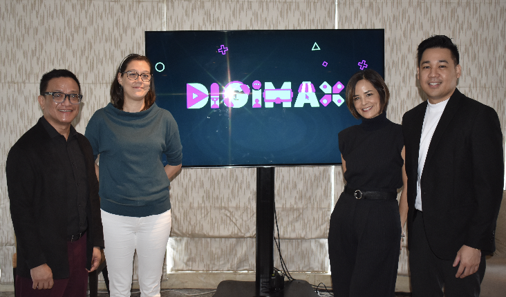 Two women standing in front of a screen

Description automatically generated