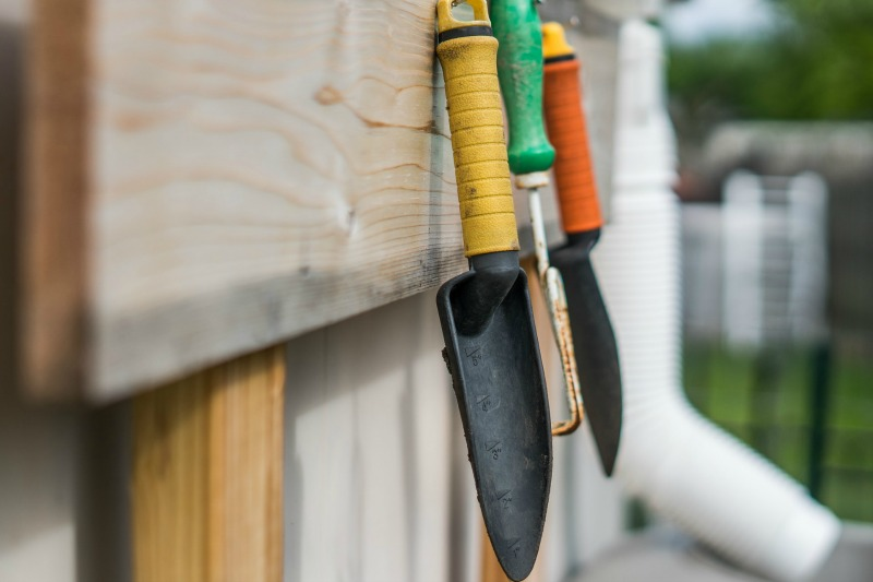 Gardening equipment hanging on an outside wall