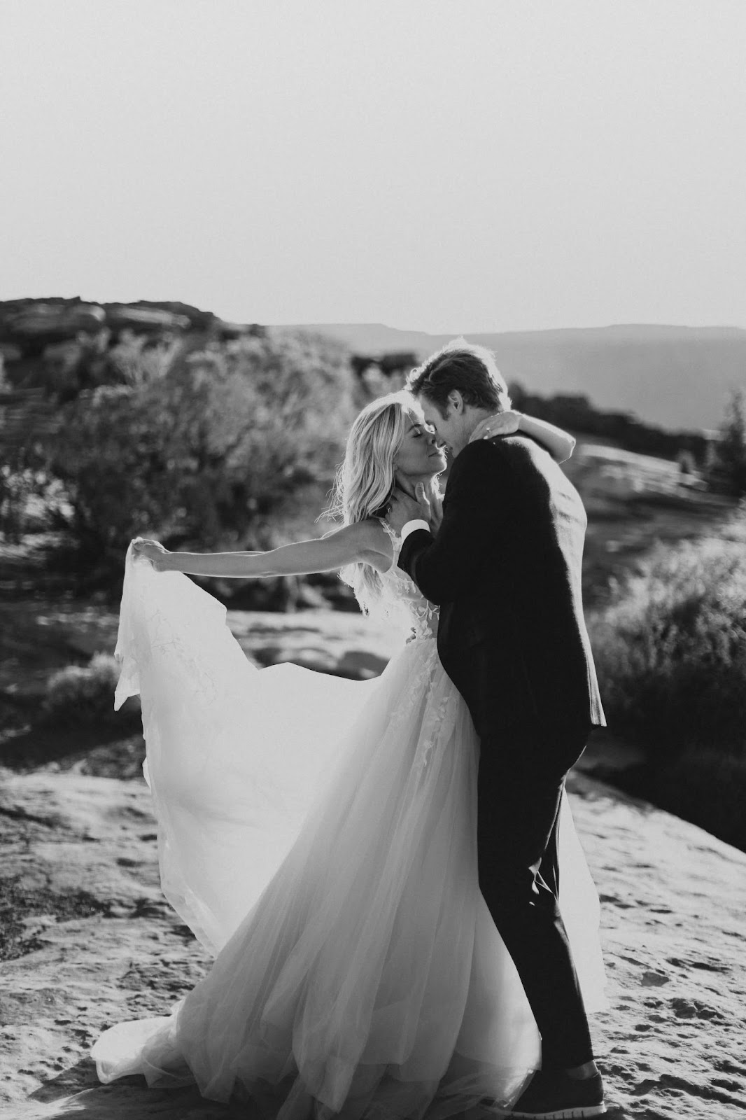 couple having a moab elopement - black and white picture