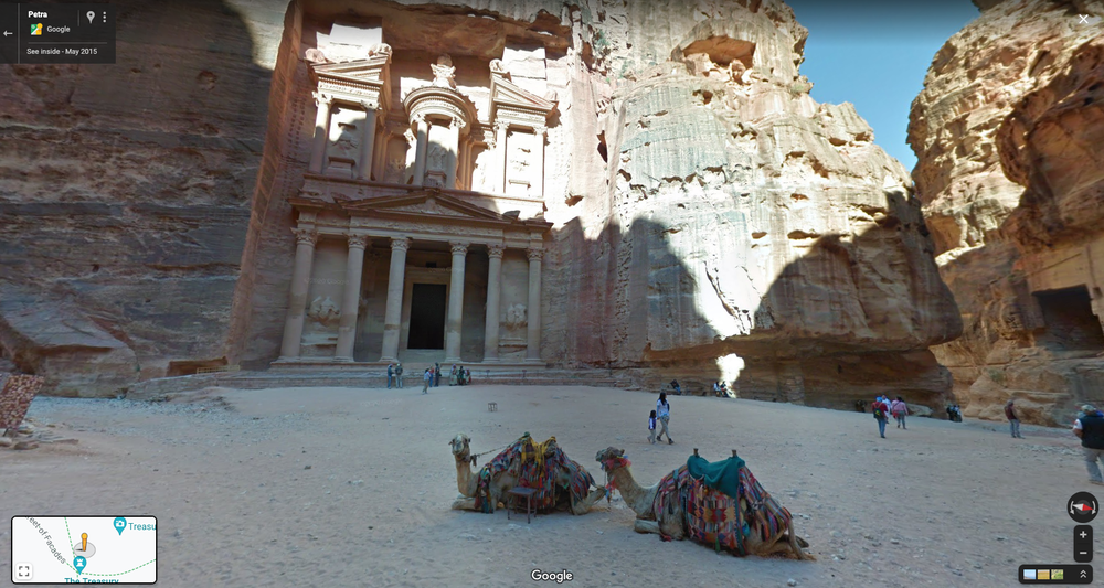 Street View image of two camels in front of a castle in the rocks