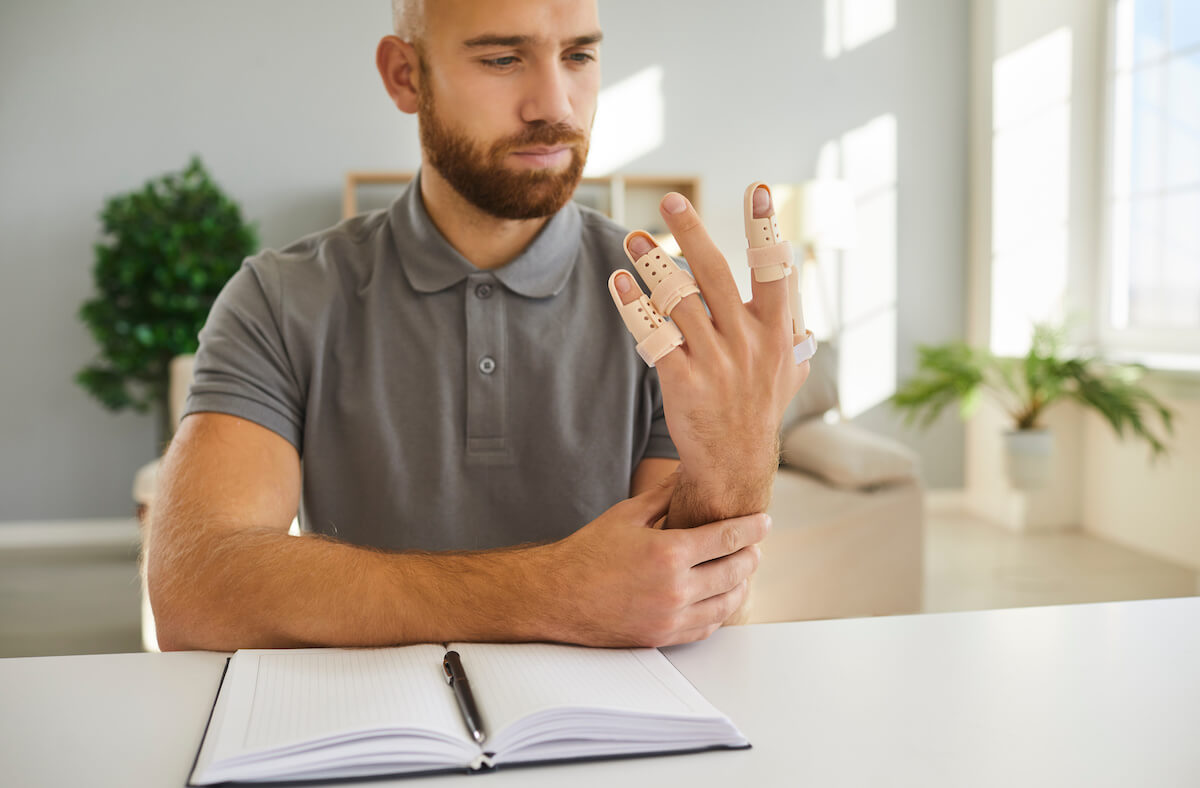 FMLA Florida: man looking at his injured hand