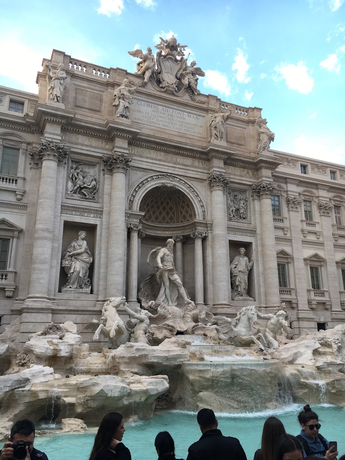 The Trevi Fountain with a bright blue sky and water