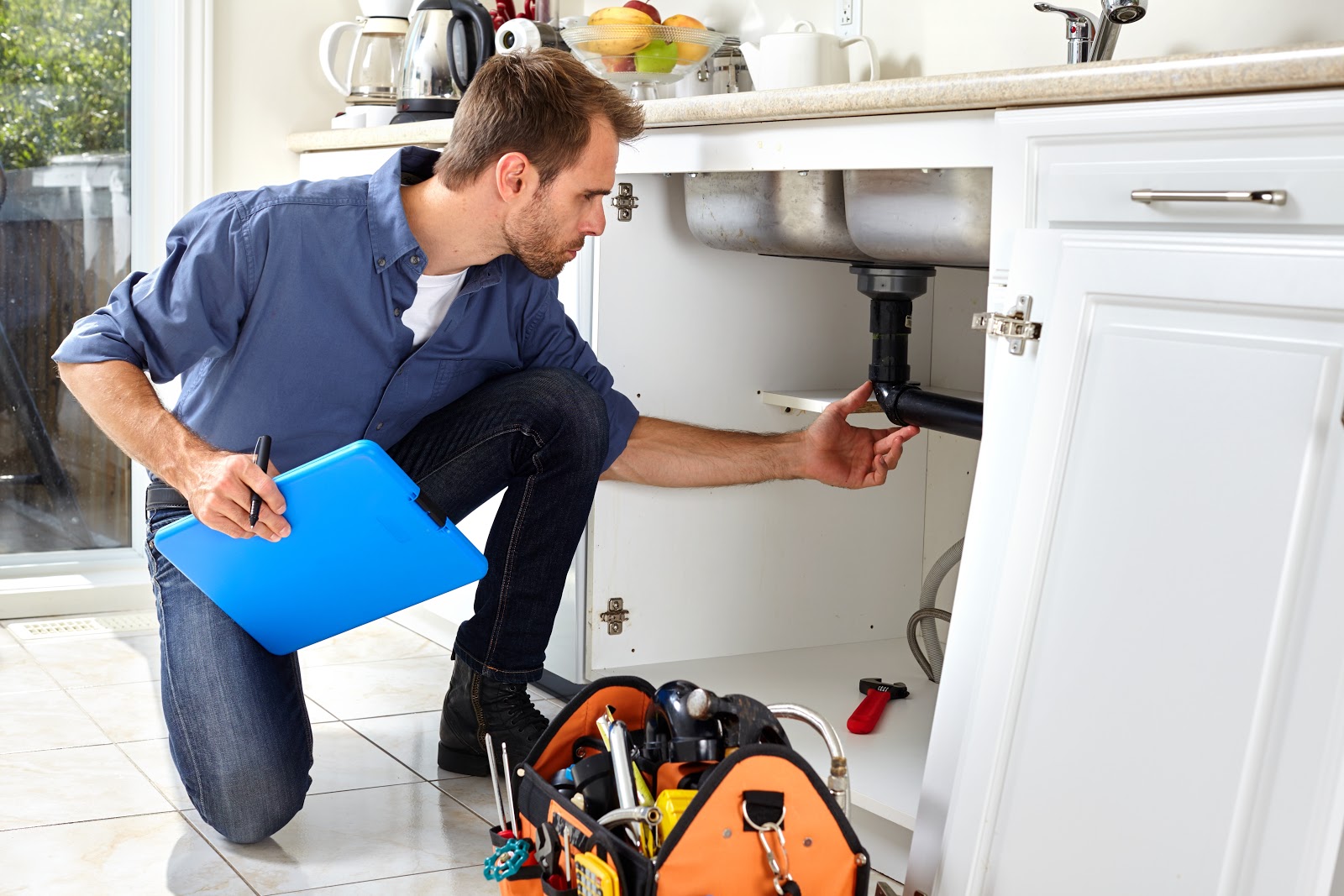 home inspector looking at sink