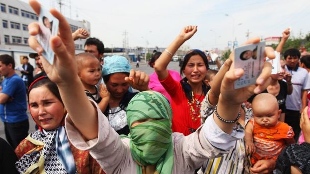 Uighur women protest against the detention of their relatives on a street in Urumqi, the capital of Xinjiang region, on 7 July 2009.