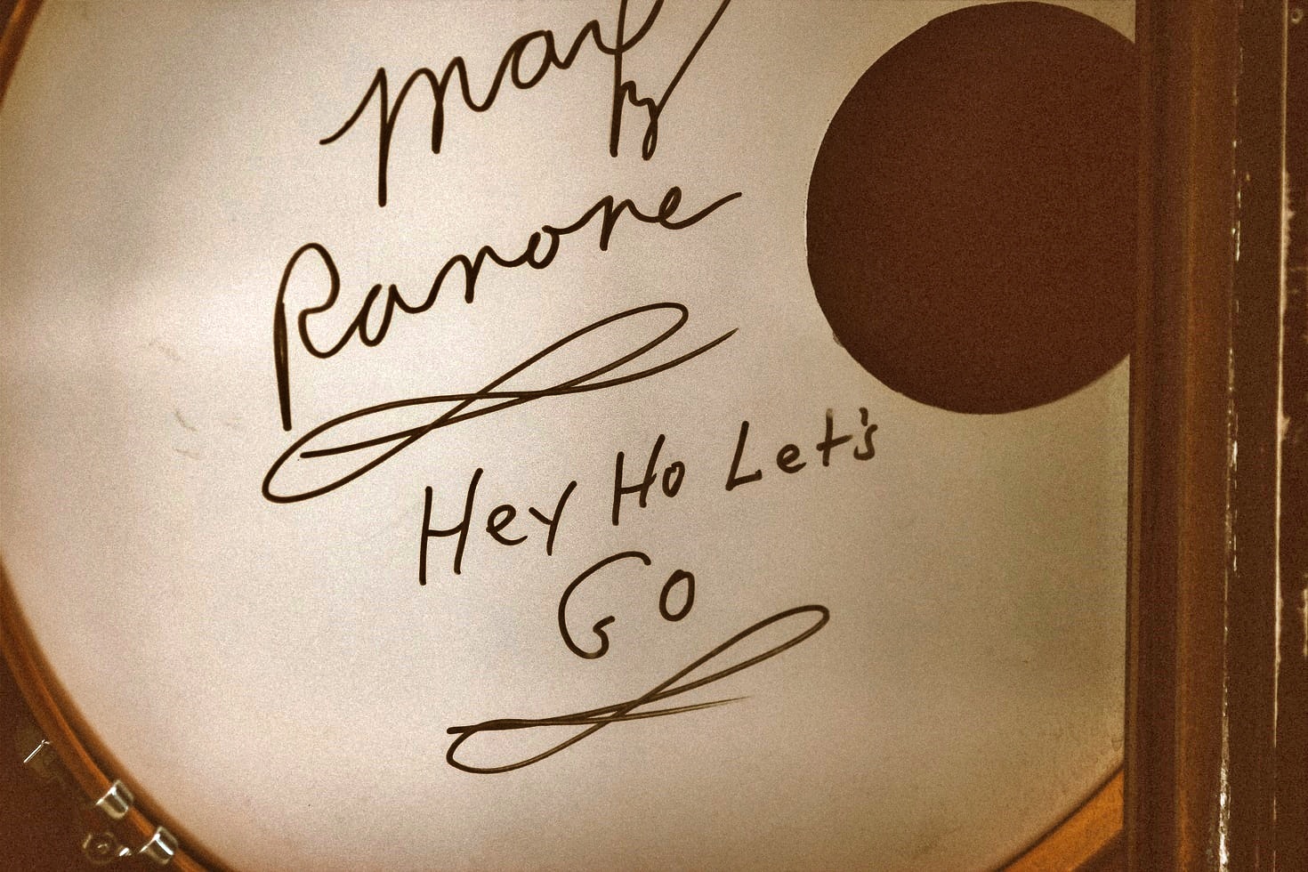A picture of an autographed kick drum from Marky Ramone, including the phrase "Hey Ho Let's Go"