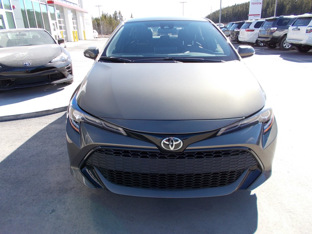 a dark gray Corolla Hatchback sits in Whitehorse Toyota's car dealership