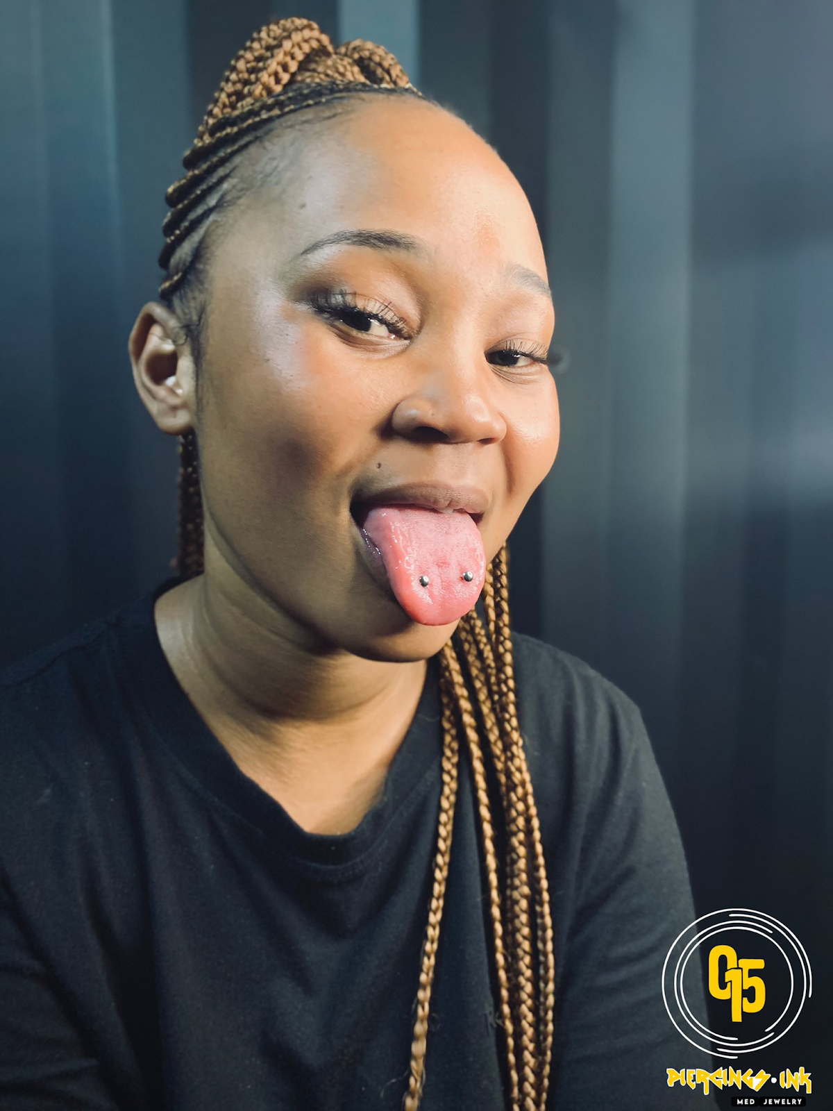Lady ooses for a selfie with her double tongue piercing