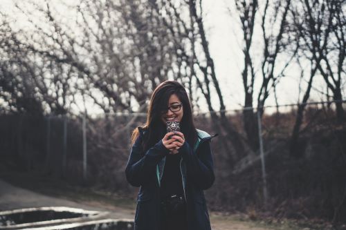 Young woman shopping on her phone with a credit card. 