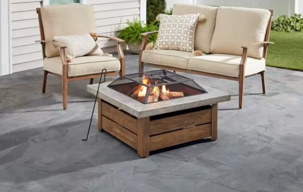 fire pit at center of patio with chairs arranged around it