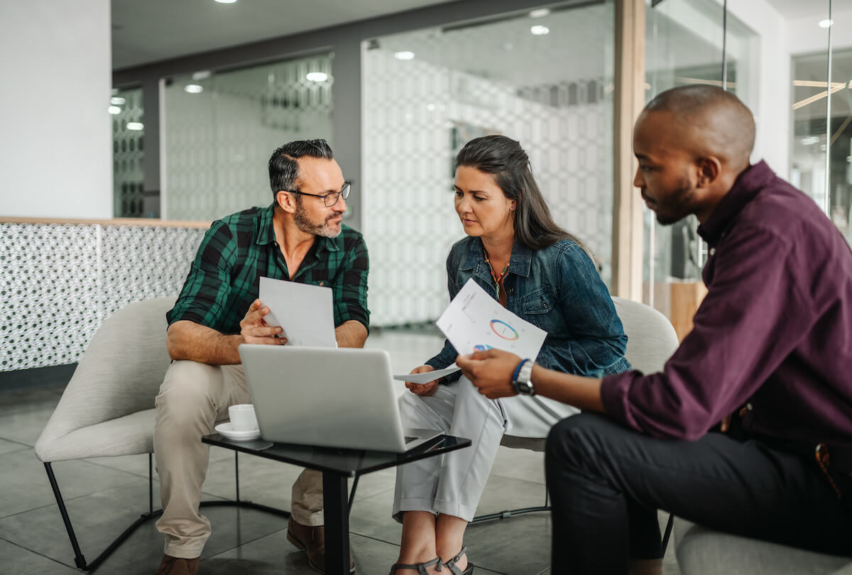 Payroll processing: group of entrepreneurs discussing some documents