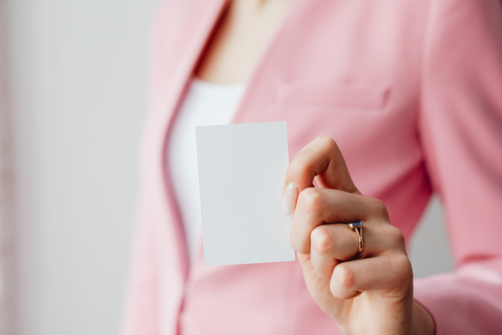 image depicting a woman holding a blank business card