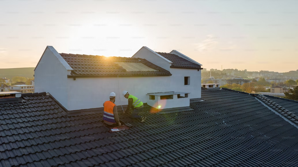 Roofing professionals working on a home roof