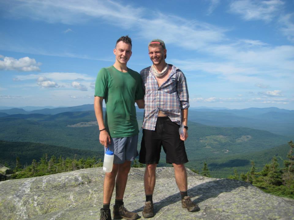 Two people posing atop a mountain along the AT