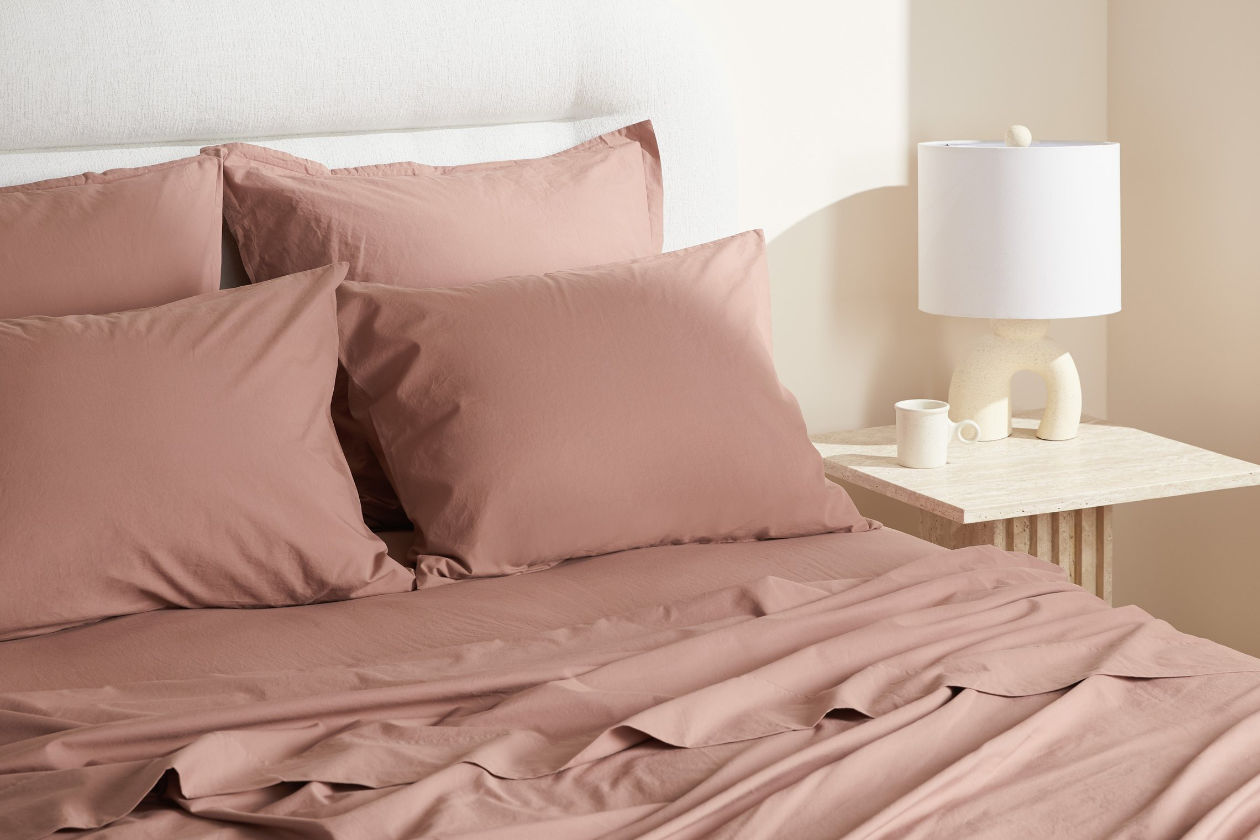 Clay-colored sheets on bed