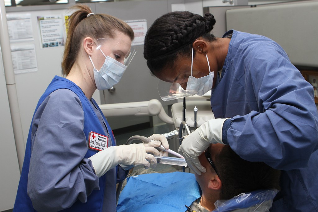Dental students practicing on a patient