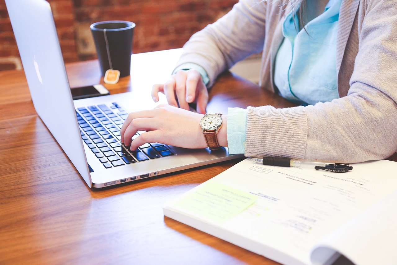 a man typing on his laptop