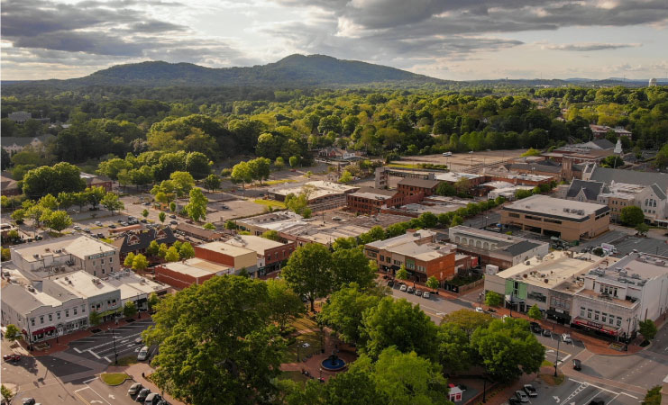 Downtown Marietta, Georgia, with the tree-lined square, surrounding woodlands, and the mountains in the background.