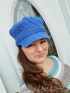 woman wearing a blue crochet newsboy hat