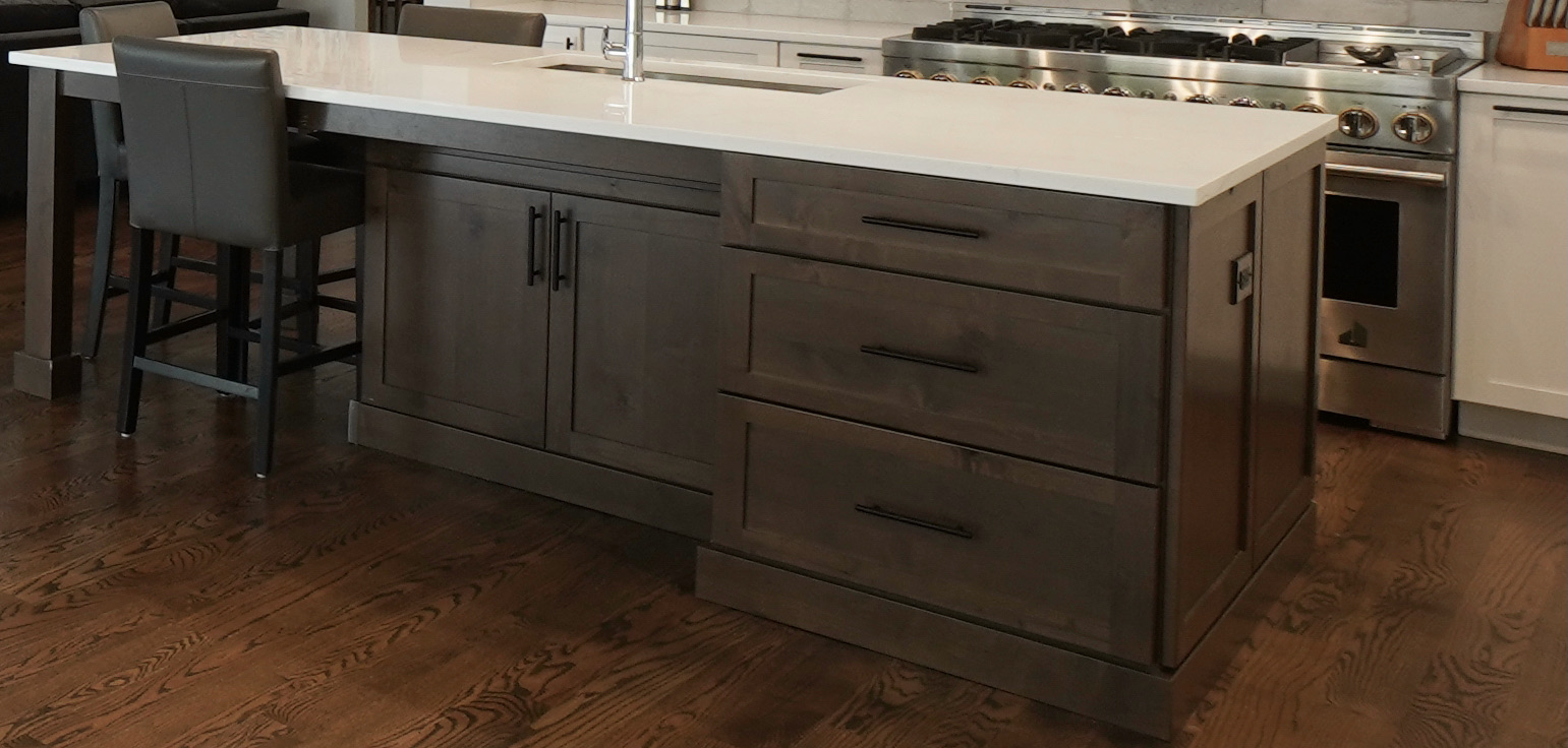 Walnut Kitchen Island with white quartz countertops and recessed cabinets.