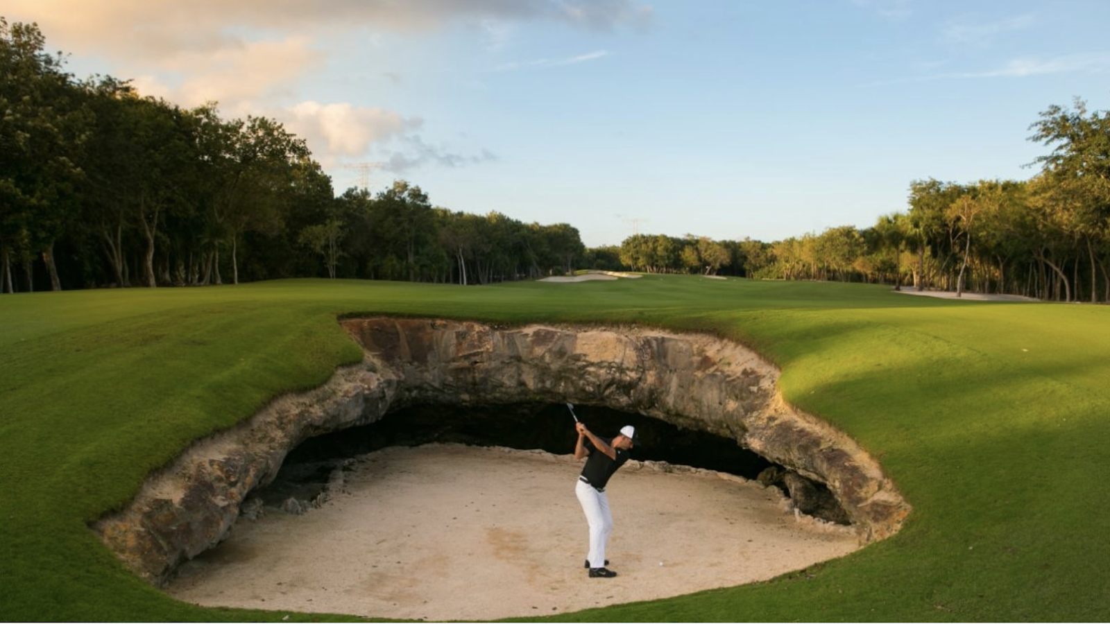 golfer hitting ball out of sand