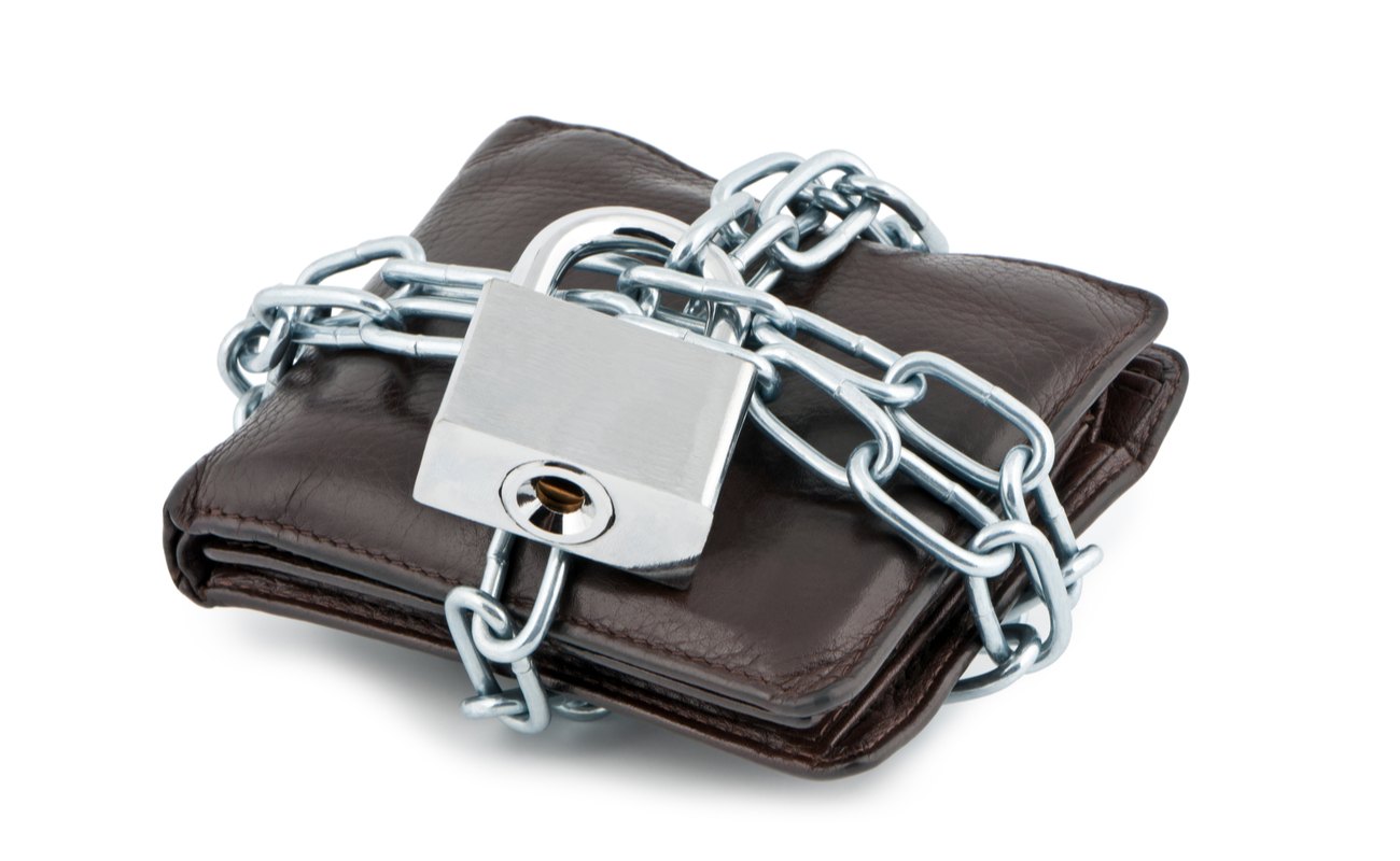 A brown wallet locked up with chains and padlock