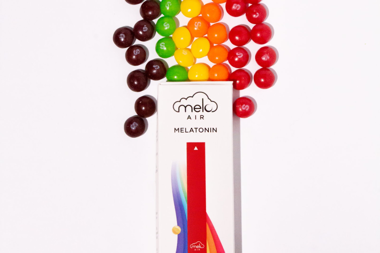 a single box of MELO Air in Rainbow Road flavor with multi-colored button-shaped chocolates