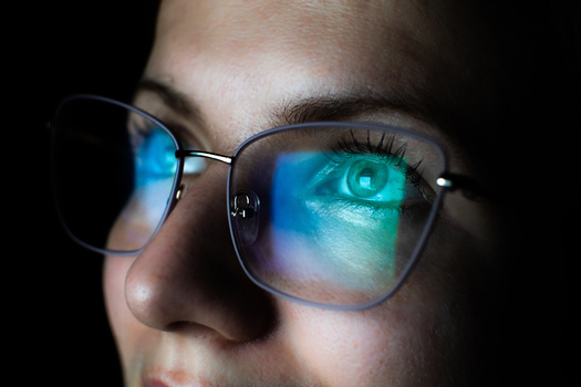 a close-up of a person's face wearing glasses