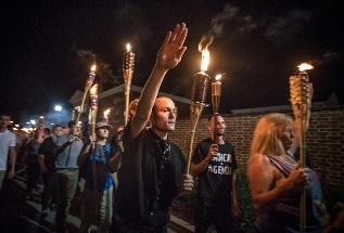 A person holding a torch in front of a crowd of people

Description automatically generated with low confidence