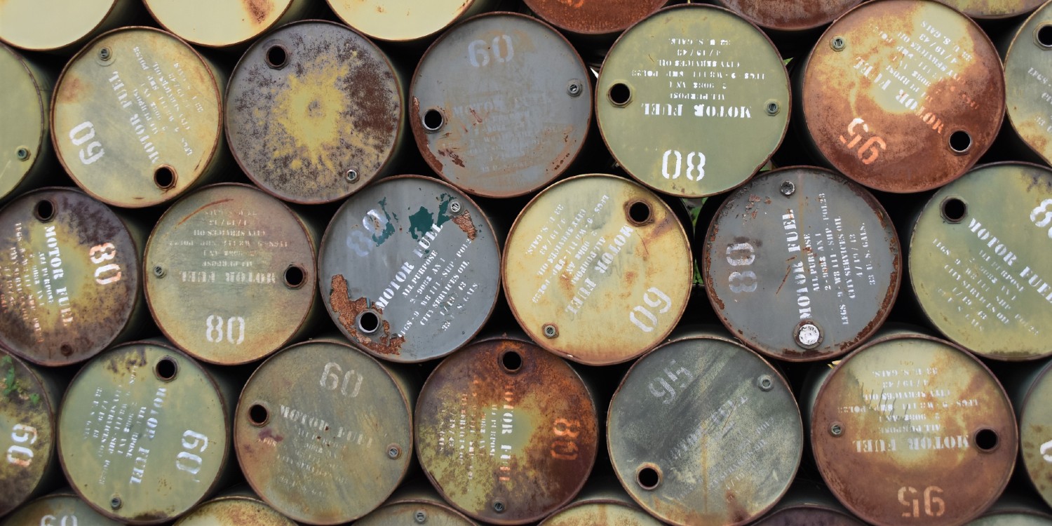 used oil barrels stacked up as an indicator of sustainability in ecological time