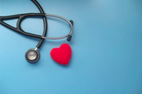 A stethoscope and red heart on a blue background.