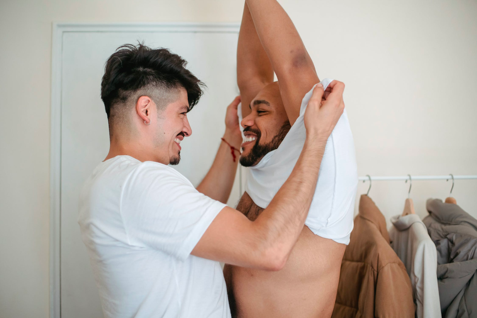 A man undressing another man