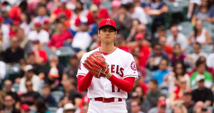 Los Angeles Angels’ Shohei Ohtani gets ready to make a pitch, with the ball in his glove and the crowd watching intently behind him