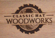 A circular saw blade with wood grain effect inside and hat to symbolize the business name, which uses a classic looking font.