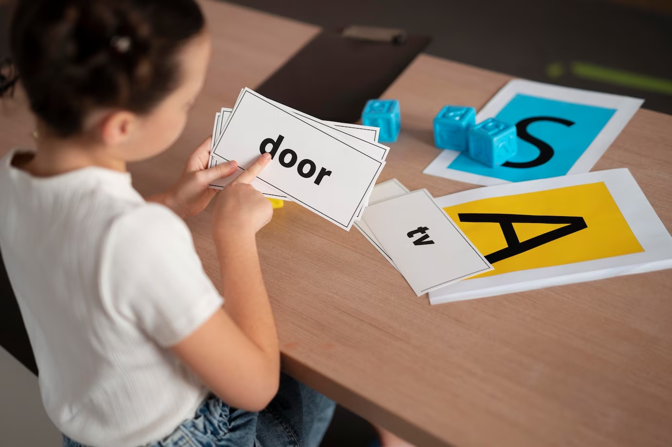 A little girl learning English phonics