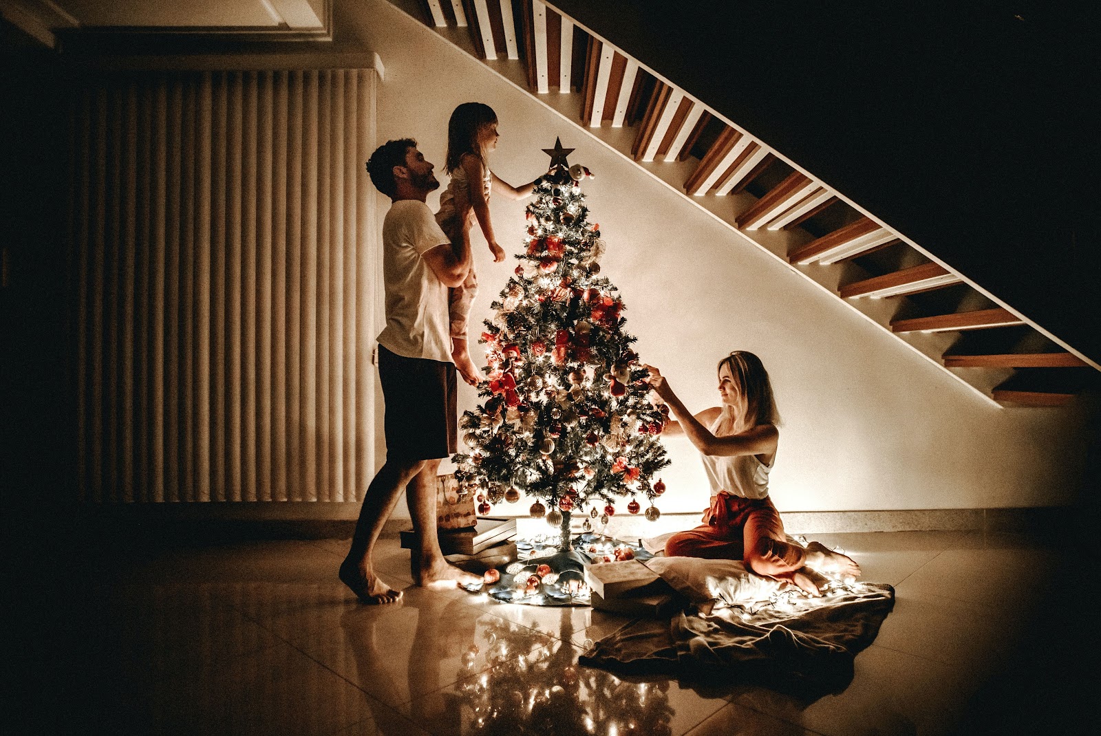 A family decorating a Christmas tree.