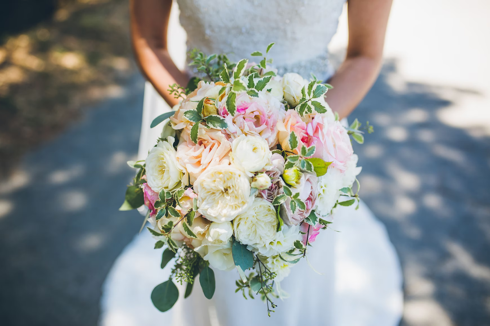 bride with white and pink wedding bouquet to do week before wedding