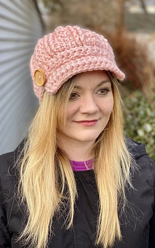 woman wearing pink newsboy hat with buttons