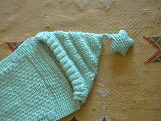 light green hooded sleep sack with star on top of hood