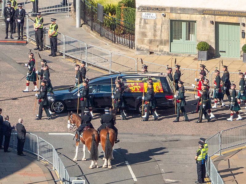 A black hearse carrying Queen Elizabeth's coffin up the Royal Mile in procession