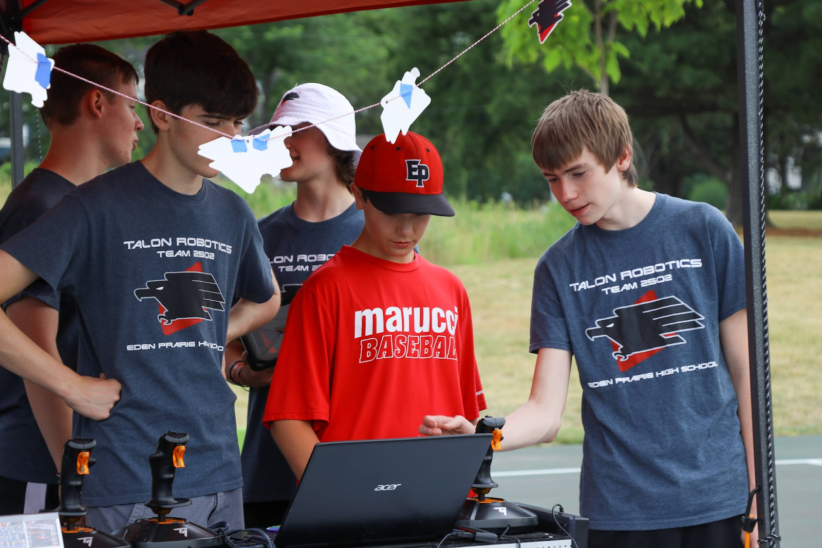 A child and two students driving the robot.