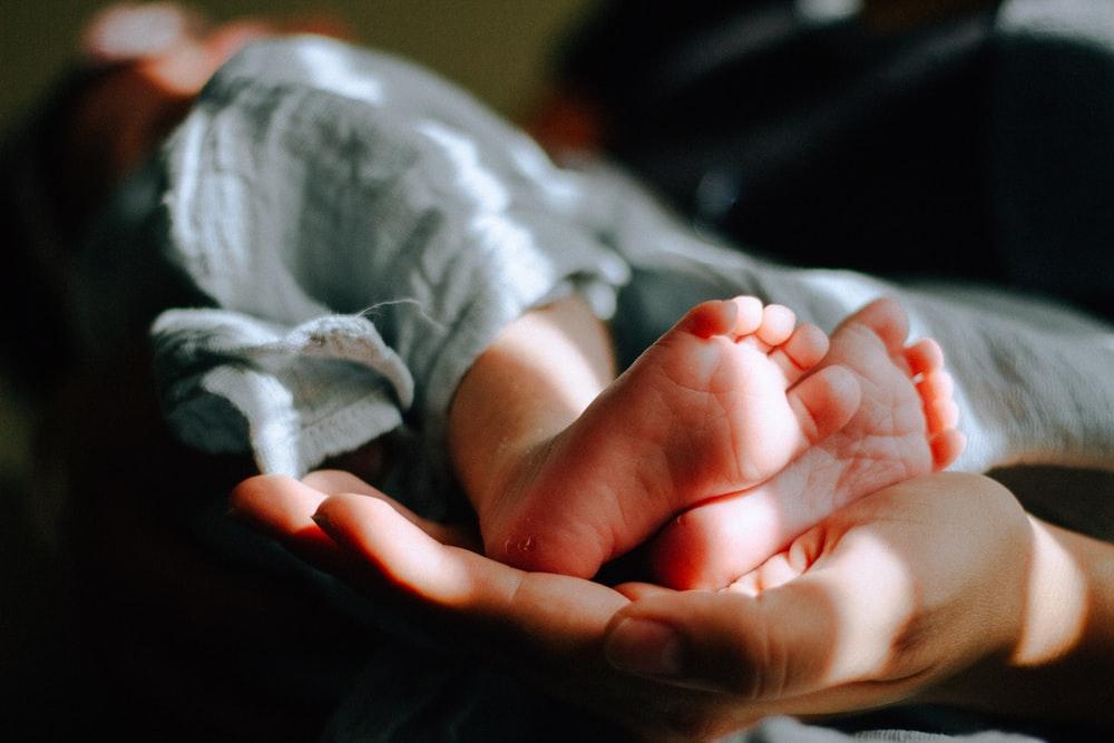 person holding baby feet
baby waking up too early