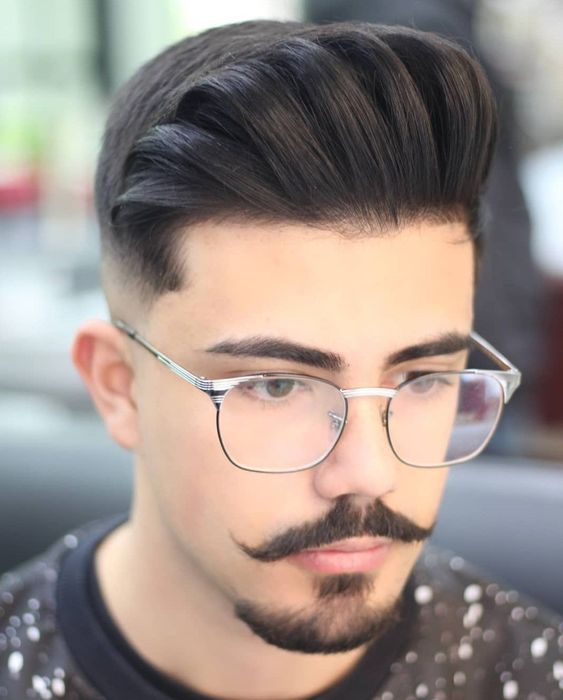 man in glasses wearing modern handlebar mustache style