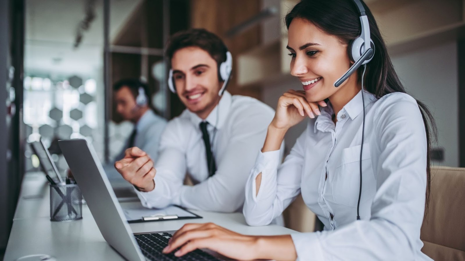 A row of contact center outsourcing agents busy enjoying their work. 