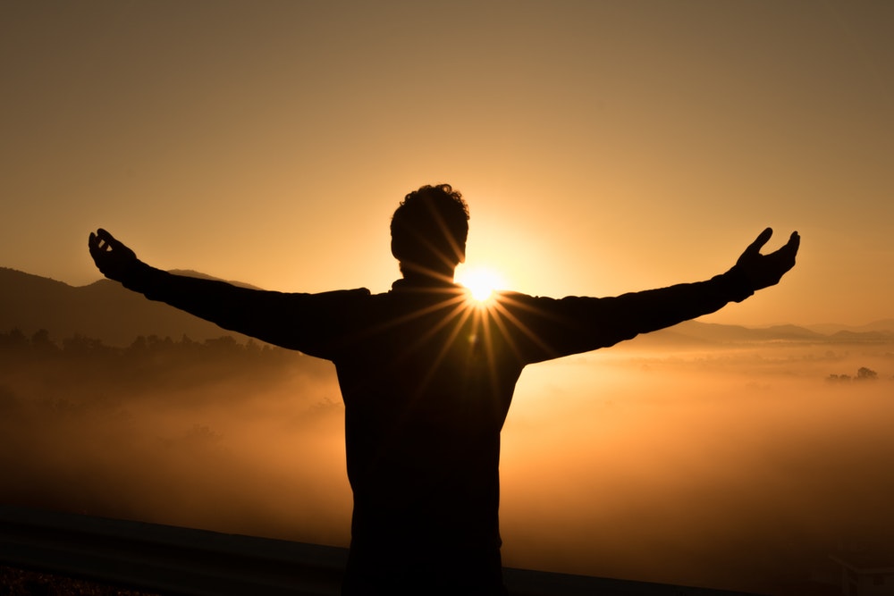 silhouette photo of man on cliff during sunset - Photo by Zac Durant on Unsplash