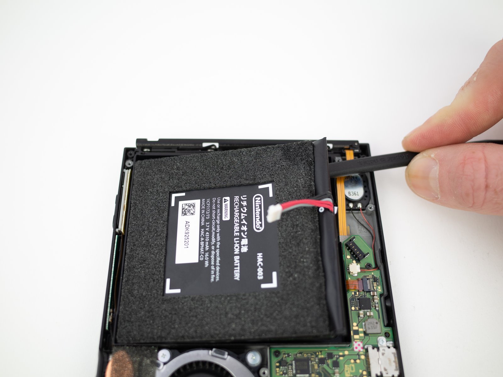 Switch console battery replacement with spudger