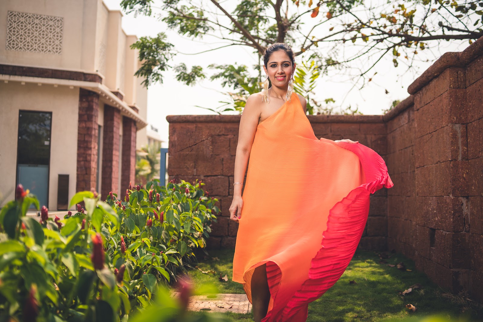 Lady posing in orange dress for a sunset photoshoot in Goa by Holidaygrapher localgrapher travelsoot