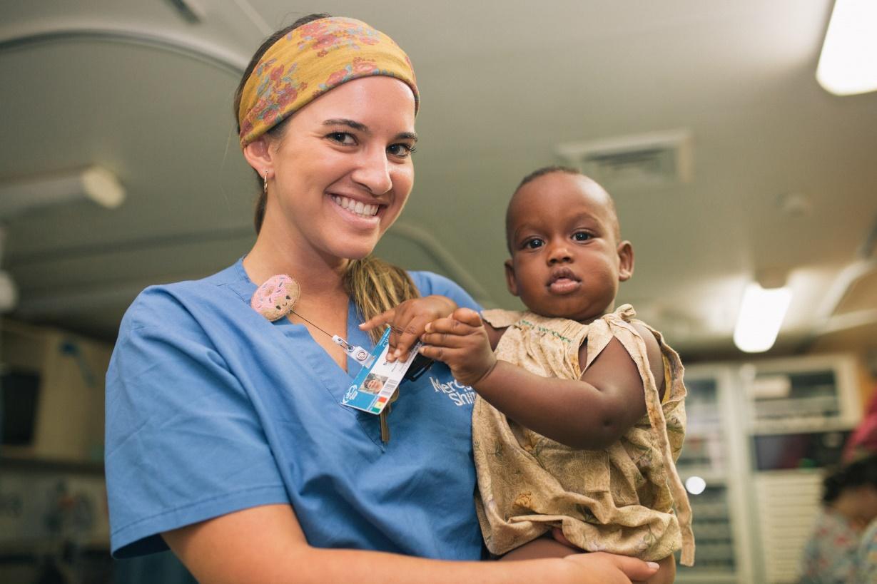 a nurse holding a baby 