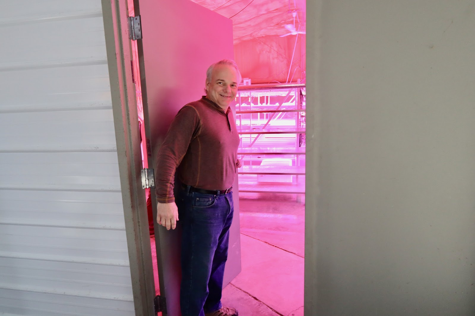 Stuart Raburn takes Bham Now on a tour of the seedling and microgreen grow room. The system is entirely automated, controlling the humidity, light and temperature by sensors. (Photo by Christine Hull for Bham Now) ﻿