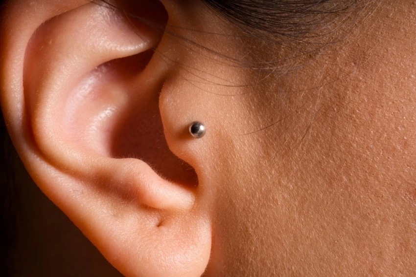 up close image of tragus piercing 