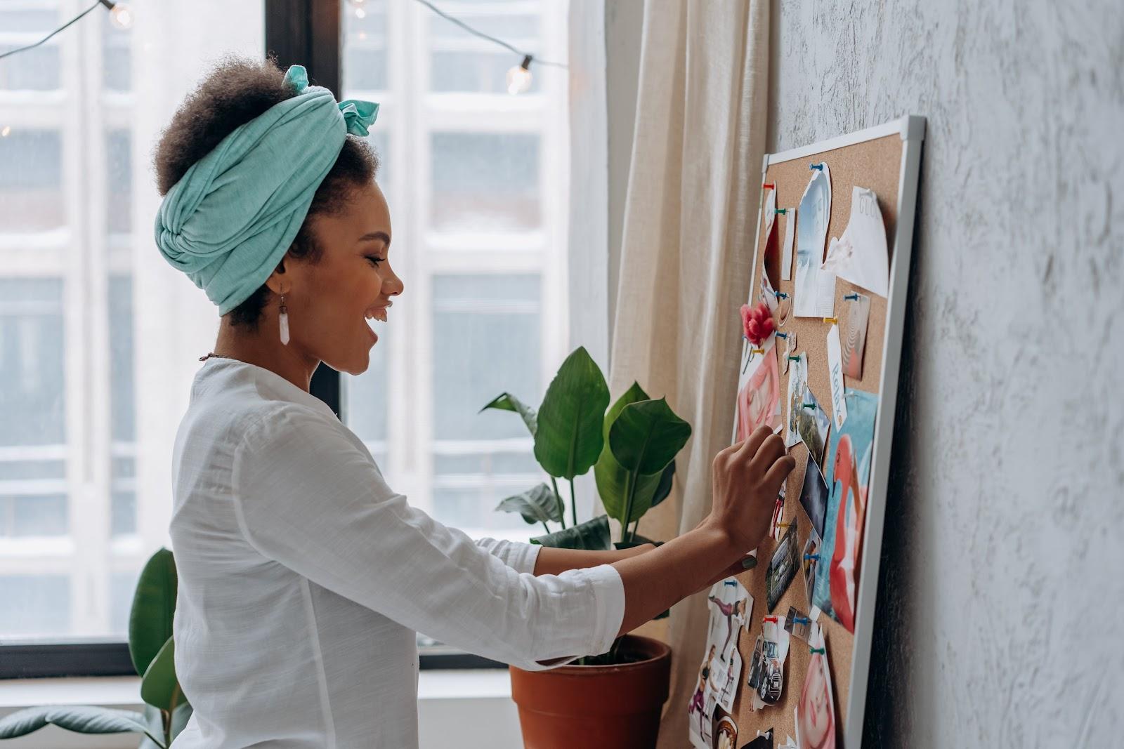 Woman in White Long Sleeve Shirt Painting on White Wall